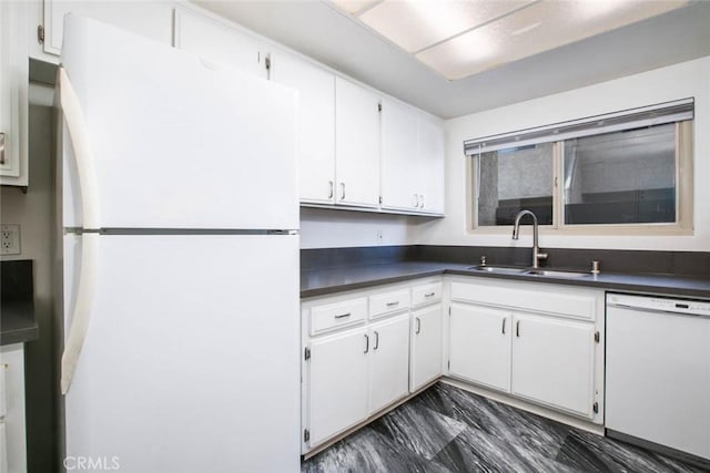 kitchen with sink, white cabinets, and white appliances