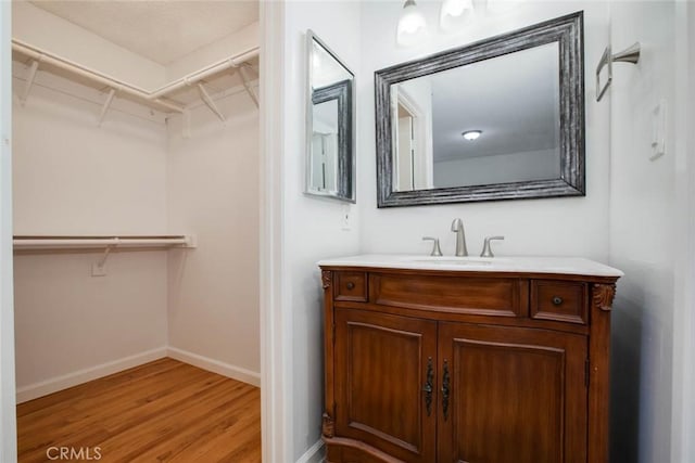 bathroom featuring hardwood / wood-style flooring and vanity