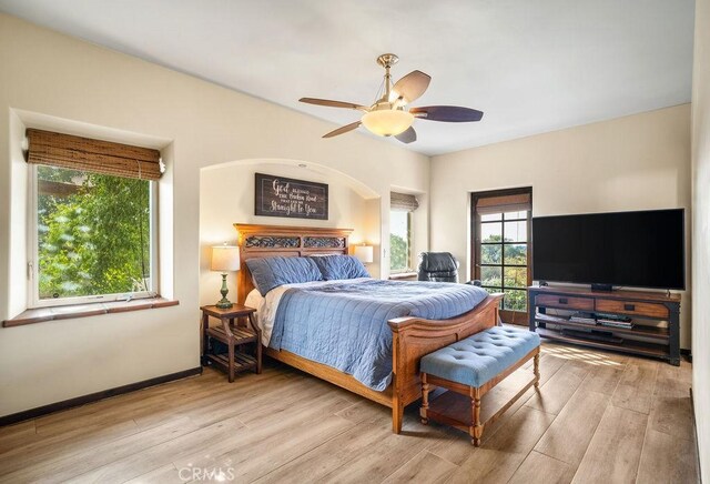 bedroom with ceiling fan and light hardwood / wood-style flooring