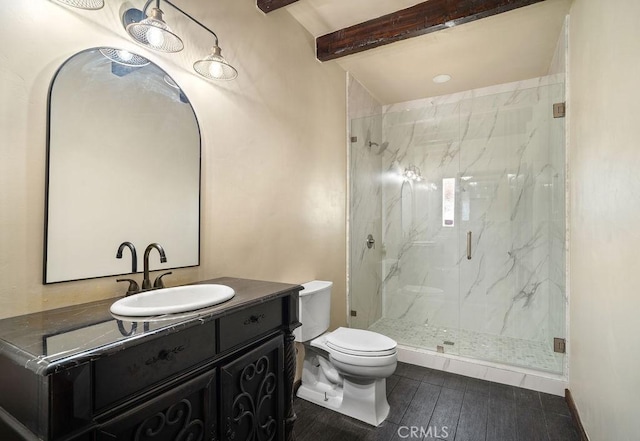 bathroom with toilet, walk in shower, beam ceiling, and vanity