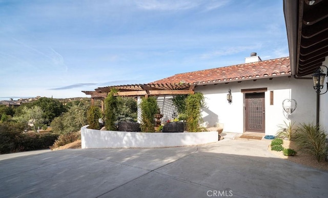 view of front facade featuring a pergola and a patio area