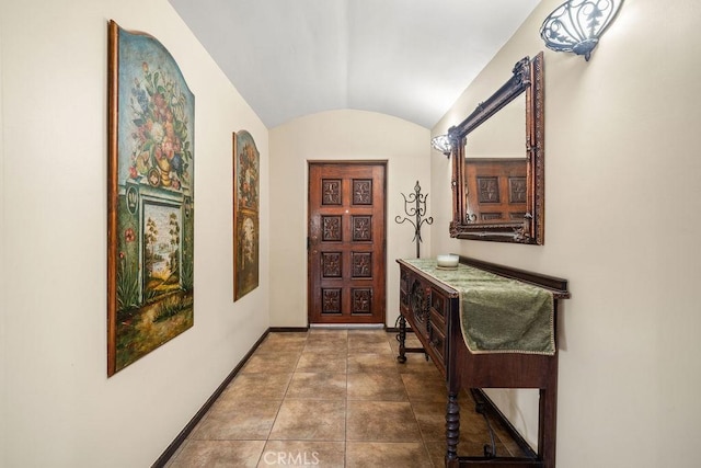 hall featuring brick ceiling and vaulted ceiling