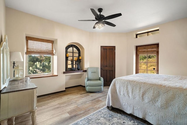 bedroom with ceiling fan and light hardwood / wood-style floors