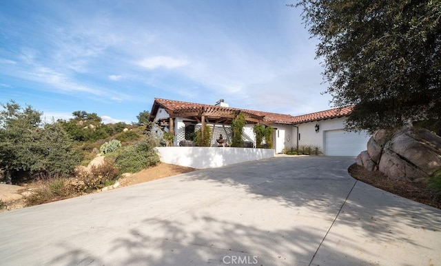 mediterranean / spanish home featuring a garage