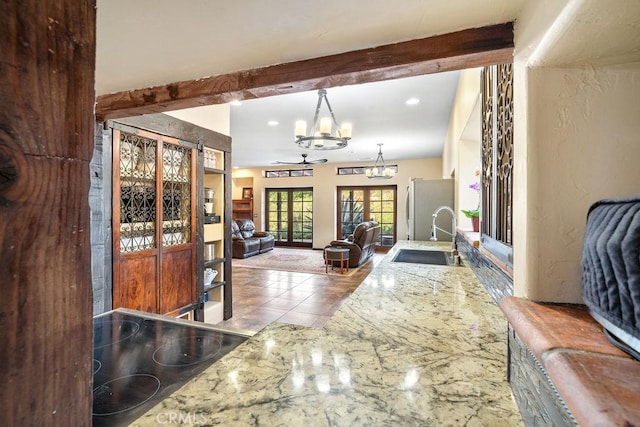 entrance foyer with ceiling fan, beam ceiling, and sink