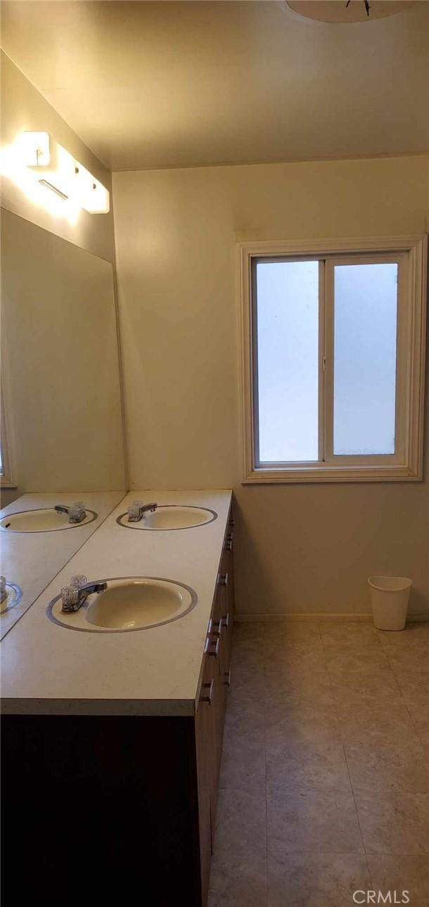 bathroom featuring tile patterned flooring and vanity