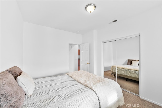 carpeted bedroom with a closet