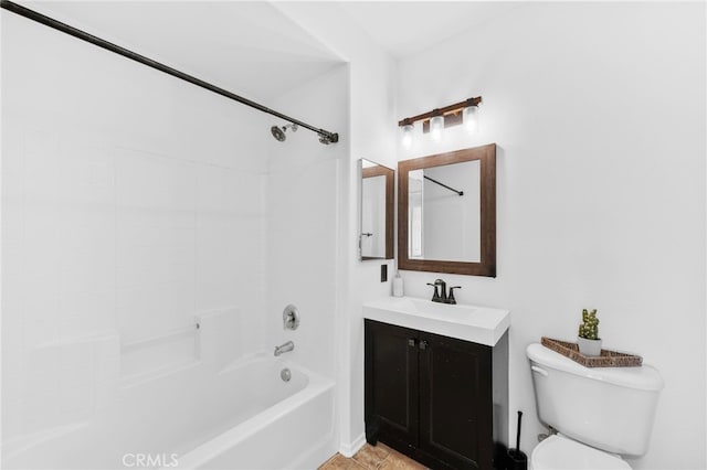 full bathroom featuring tiled shower / bath combo, toilet, and vanity