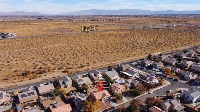 birds eye view of property with a mountain view