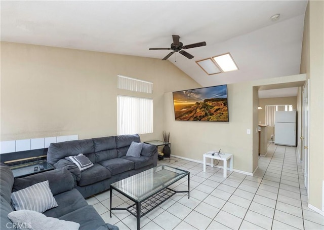 living room with ceiling fan, light tile patterned flooring, and lofted ceiling