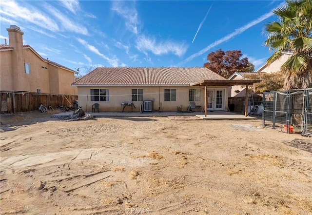 rear view of house with central AC