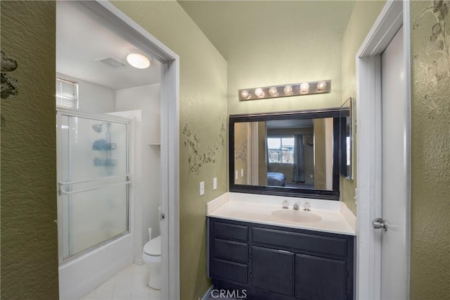 full bathroom with vanity, toilet, and bath / shower combo with glass door