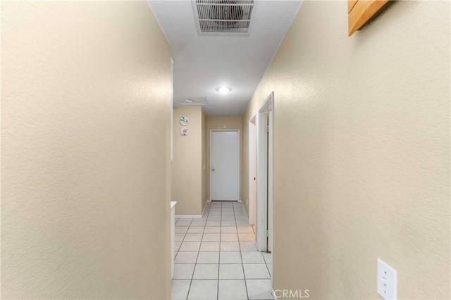 hall with light tile patterned floors