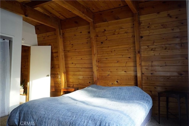 bedroom with carpet, wood walls, beamed ceiling, and wood ceiling