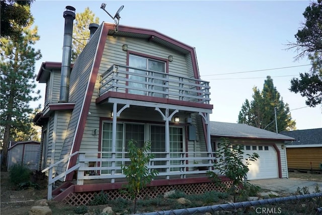 view of front of home with a balcony and a garage