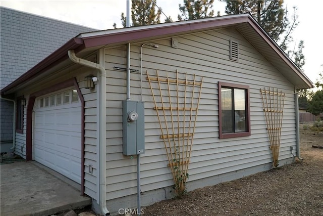 view of side of home featuring a garage