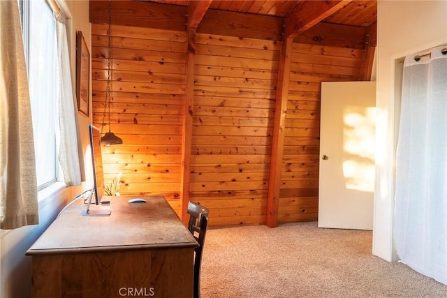 home office with beam ceiling, wooden ceiling, light carpet, and wooden walls