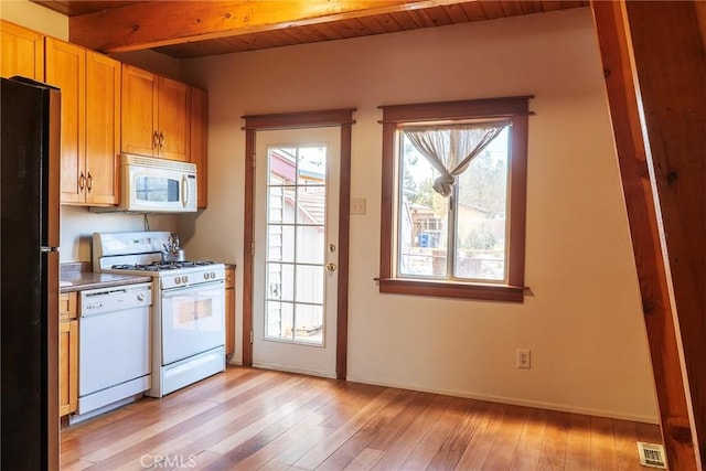 kitchen with light hardwood / wood-style floors, white appliances, beam ceiling, and wood ceiling