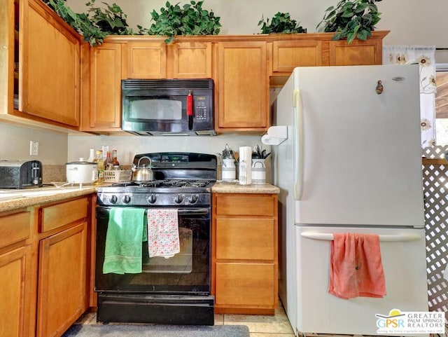 kitchen with black appliances and light tile patterned floors