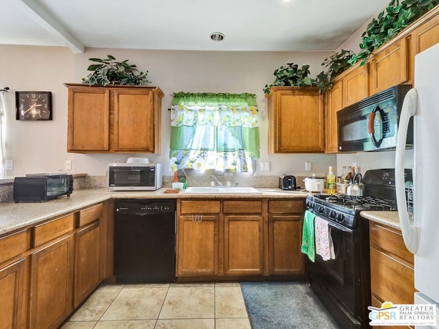 kitchen featuring black appliances, beam ceiling, light tile patterned floors, and sink