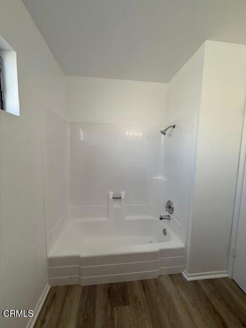 bathroom with hardwood / wood-style floors and bathtub / shower combination