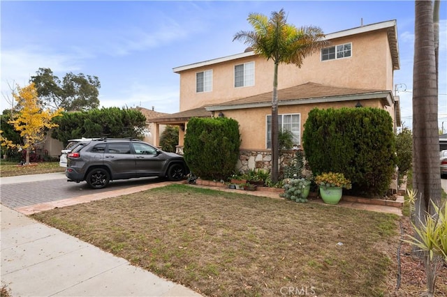 view of property featuring a front lawn