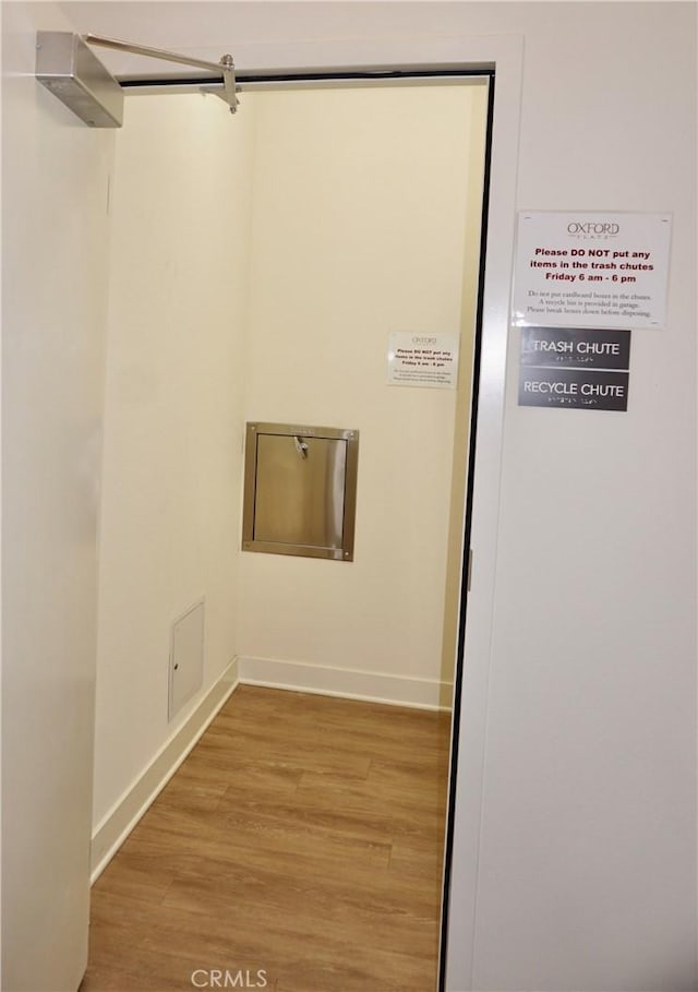 laundry area with hardwood / wood-style flooring