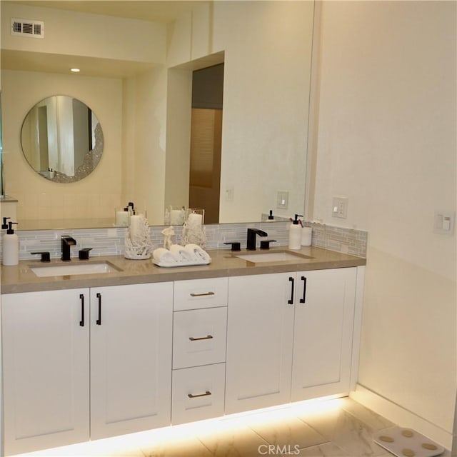 bathroom featuring decorative backsplash and vanity