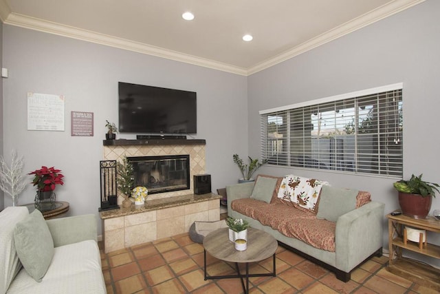 living room featuring ornamental molding, a fireplace, and tile patterned flooring