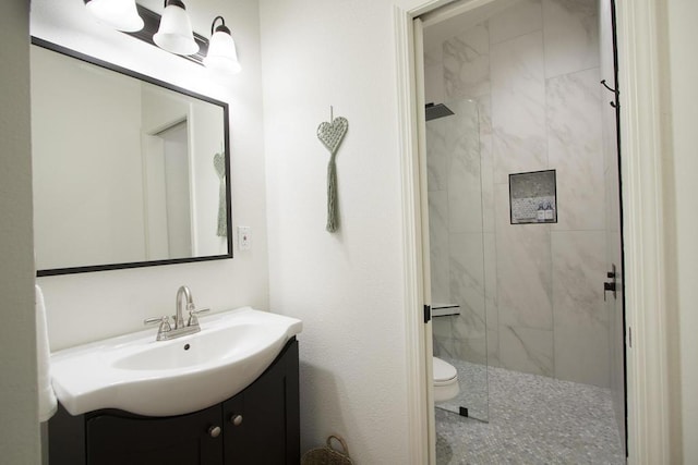 bathroom with vanity, toilet, and walk in shower