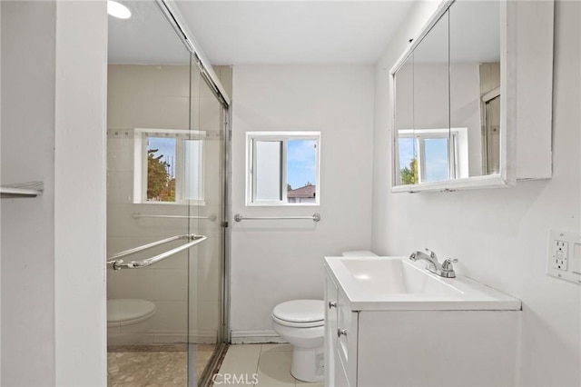 bathroom featuring tile patterned floors, vanity, toilet, and a shower with shower door