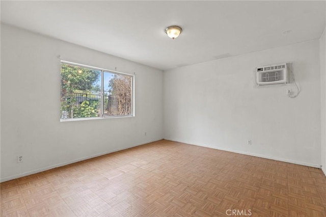 empty room with a wall unit AC and parquet floors