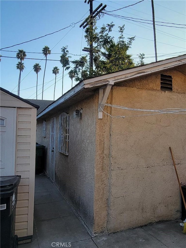 view of side of home with a storage unit