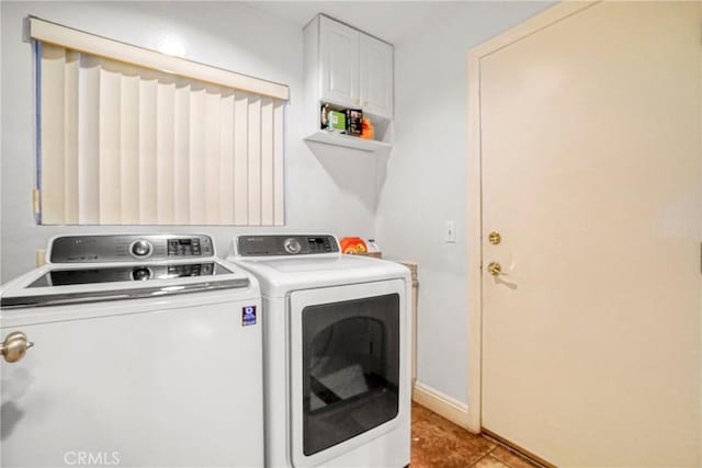 laundry room featuring light tile patterned floors and washing machine and clothes dryer