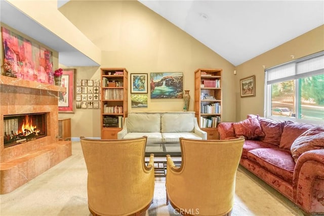 carpeted living room with a fireplace and high vaulted ceiling