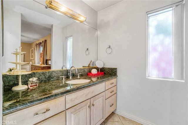 bathroom with tile patterned flooring, plenty of natural light, and vanity