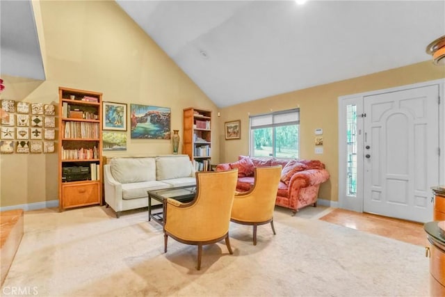 living room with light carpet and high vaulted ceiling