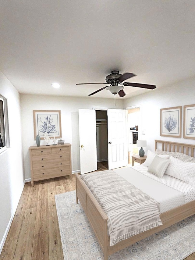 bedroom featuring ceiling fan, light hardwood / wood-style flooring, and a closet