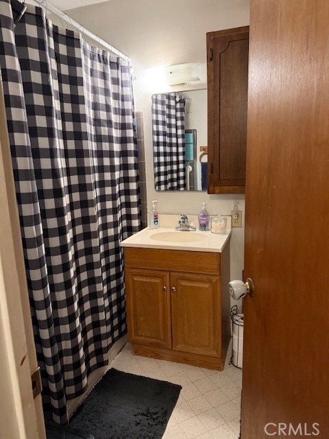 full bath with vanity and a shower with shower curtain