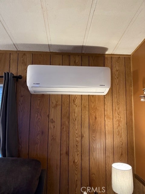 room details with wood walls and a wall mounted AC