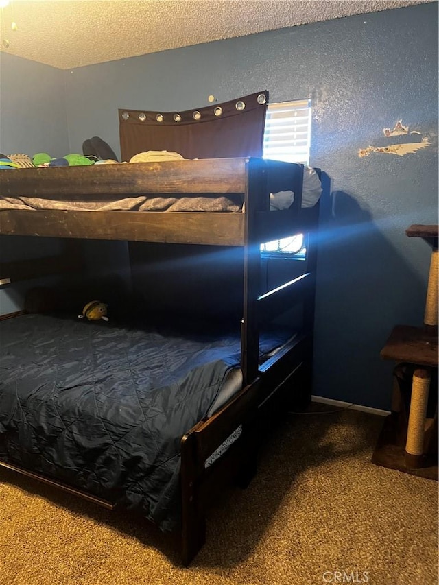 bedroom featuring carpet and a textured ceiling