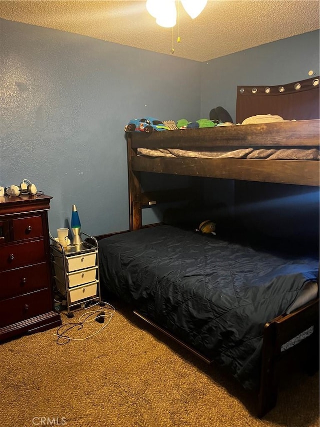 bedroom featuring carpet and a textured ceiling