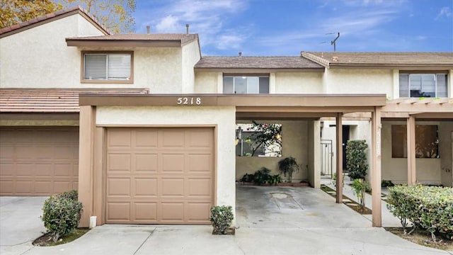 view of property featuring a garage and a carport