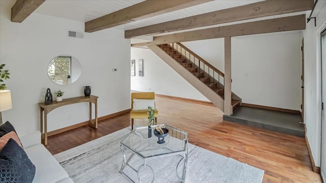 living room with hardwood / wood-style floors and beam ceiling