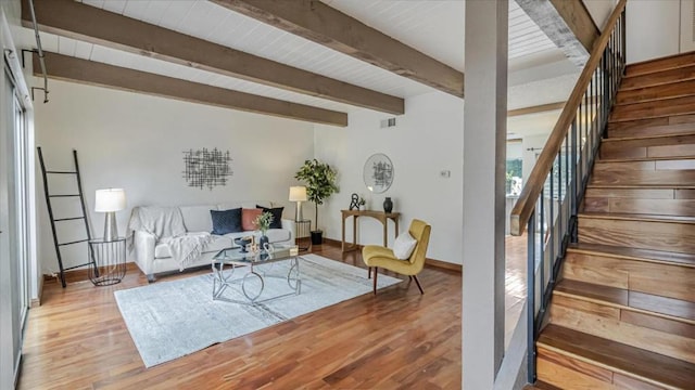 living room with light hardwood / wood-style flooring and beam ceiling