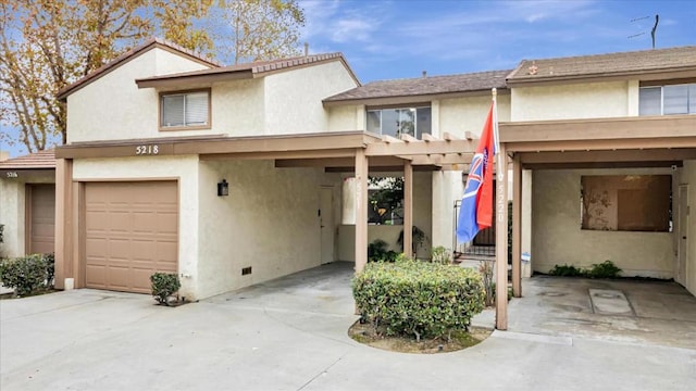 townhome / multi-family property with a garage and a carport