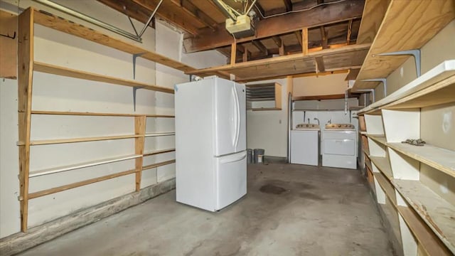 basement with white fridge and separate washer and dryer