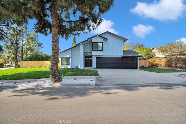 view of front facade with a garage and a front lawn