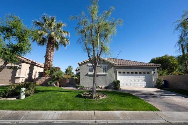 view of front of property with a front yard and a garage