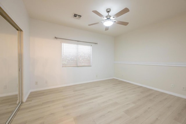 unfurnished bedroom featuring ceiling fan, light wood-type flooring, and a closet